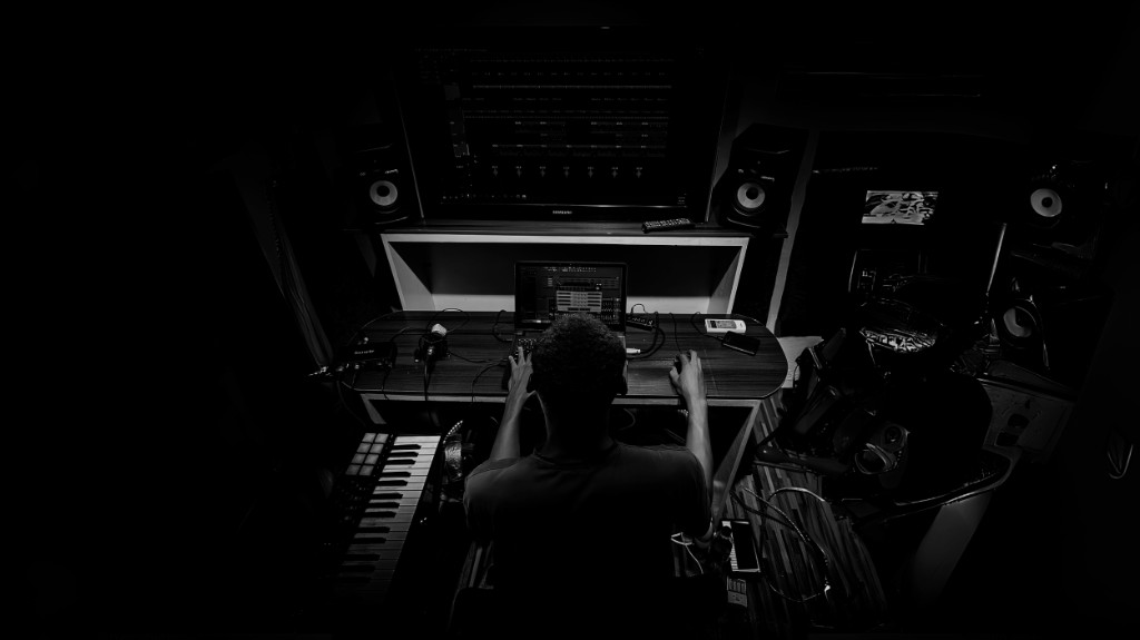 Overhead view of a session at a laptop in a dark studio